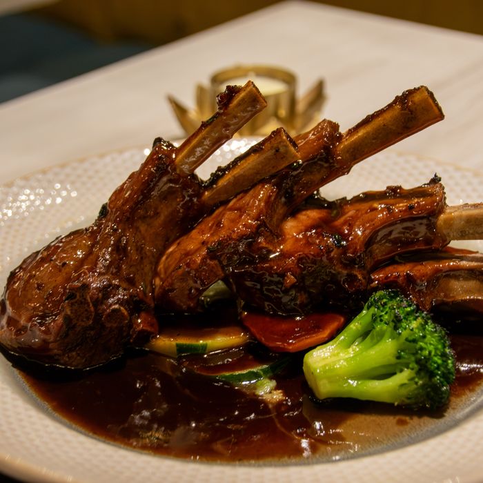 A rack of lamb chops in red wine glaze with broccoli and vegetables, plated at Restaurante Bocas